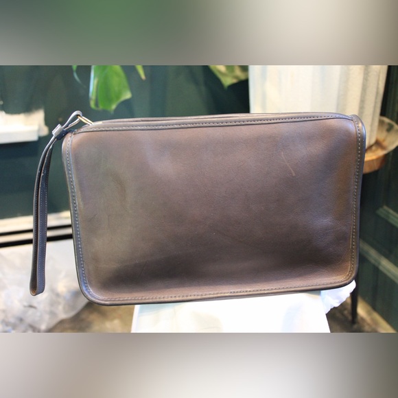 Vintage brown leather clutch is a Coach NYC Bonnie Cashin Basic Bag.